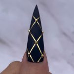 Gothic Glam: Black and Gold Stiletto Nails
