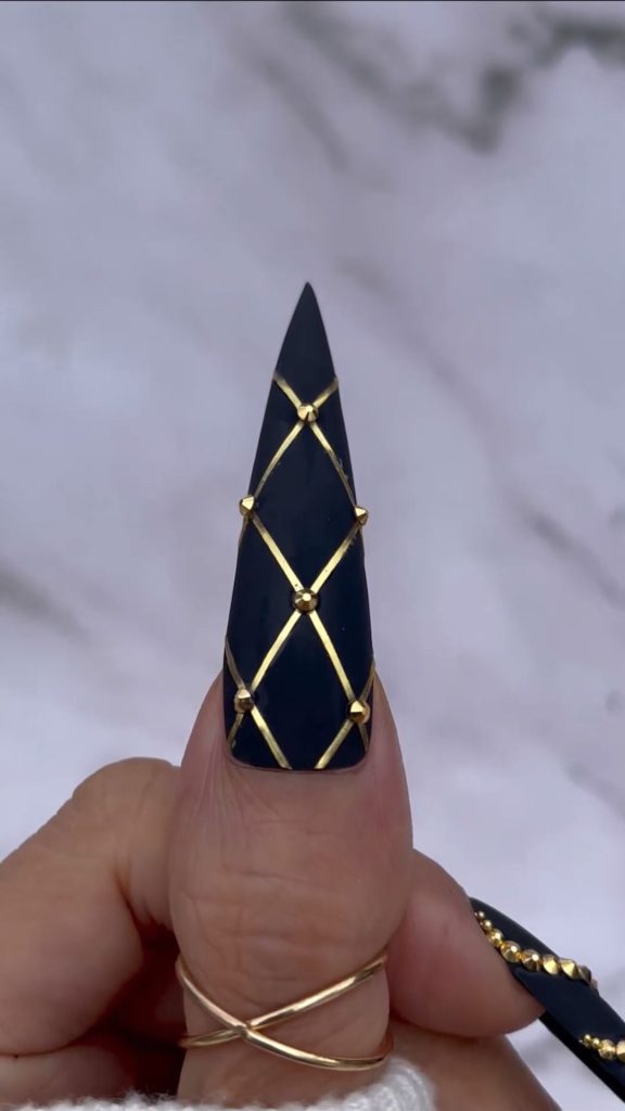 Gothic Glam: Black and Gold Stiletto Nails